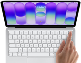 MacBook Neo, couleur argent, affichant l’écran de connexion, doigt d’une personne sur le capteur Touch ID situé dans le coin supérieur droit du clavier